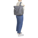 HUGGIES Cozy Hugpack Tote Diaper Bag in Quiet Smoke Quilted pattern, modeled by a person wearing casual attire.