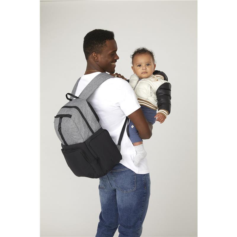 HUGGIES Day Pack Diaper Backpack in Bridal Rose/Two Tone on a man’s back, holding a baby dressed in a light jacket.