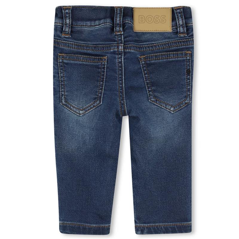 Denim pants for boys by Hugo Boss in dark wash cotton, featuring back pockets and branded leather patch.