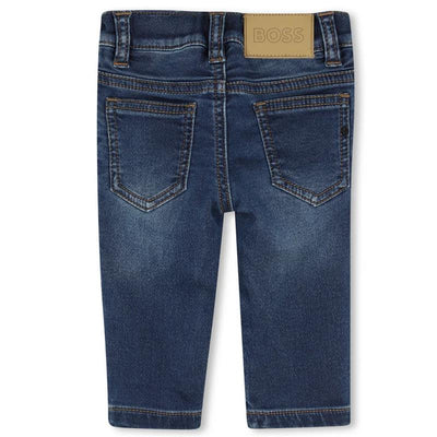 Denim pants for boys by Hugo Boss in dark wash cotton, featuring back pockets and branded leather patch.