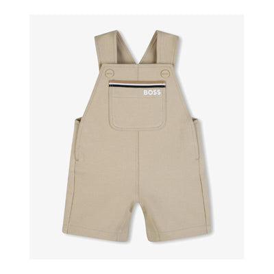 Cotton shortalls for infants by Hugo Boss, in a light stone color, featuring adjustable straps and a front pocket.