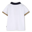 White cotton polo shirt with a navy collar and beige cuffs, featuring the Hugo Boss logo.