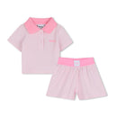 Light pink Hugo Boss polo shirt and shorts set for girls, featuring a collared shirt with logo and elastic waistband shorts.