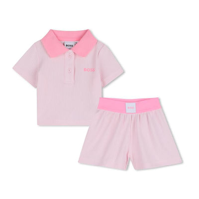 Light pink Hugo Boss polo shirt and shorts set for girls, featuring a collared shirt with logo and elastic waistband shorts.
