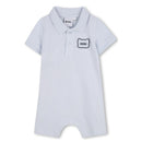 Infant short sleeve polo romper in pale blue with a black and white rubber panda patch and BOSS logo.
