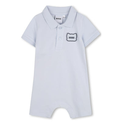 Infant short sleeve polo romper in pale blue with a black and white rubber panda patch and BOSS logo.