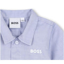 Light blue Hugo Boss baby shirt with a collar, featuring a button and the brand logo prominently displayed.