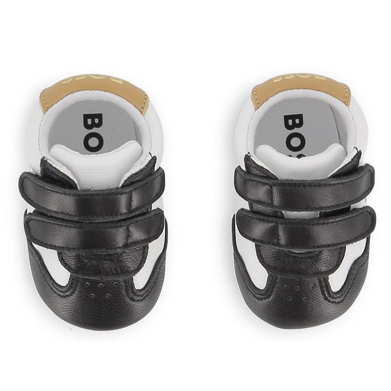 Soft black sheep leather slippers for babies by Hugo Boss, featuring Velcro straps and a stylish design.