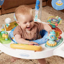 Baby enjoying the Infantino 360 Magic Motion Activity Center with colorful toys and interactive features in a cozy setting.