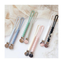Two packs of Infantino Pacigrip silicone holders in sage green and various colors, featuring textured grips and clips.