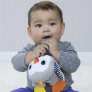 Infantino Cuddly Teether, Penguin toy held by a baby, who is sitting and chewing on it.