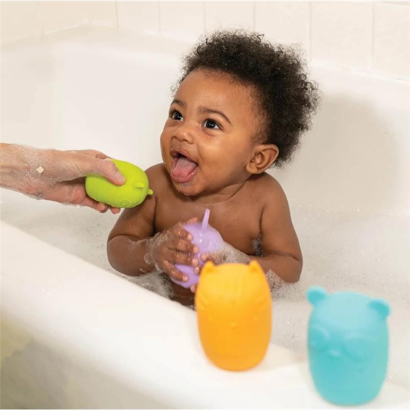 A baby joyfully interacts with colorful Infantino Easy Clean Bath Squirters in a bubble-filled bathtub.