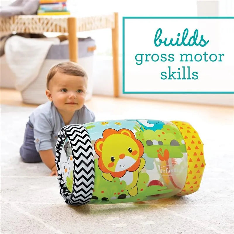 Infantino Jungle Peek & Roll toy with lion design, used by a baby to develop gross motor skills on the floor.