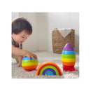 A toddler plays with the Infantino Magic Rainbow Stacker, featuring colorful stacking pieces including a rocket and rainbow.