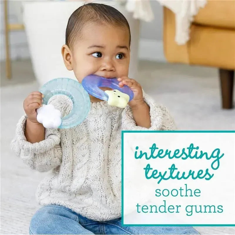 A toddler in a cozy sweater holds two Infantino Soothe & Shake Water Teethers, designed to soothe tender gums.