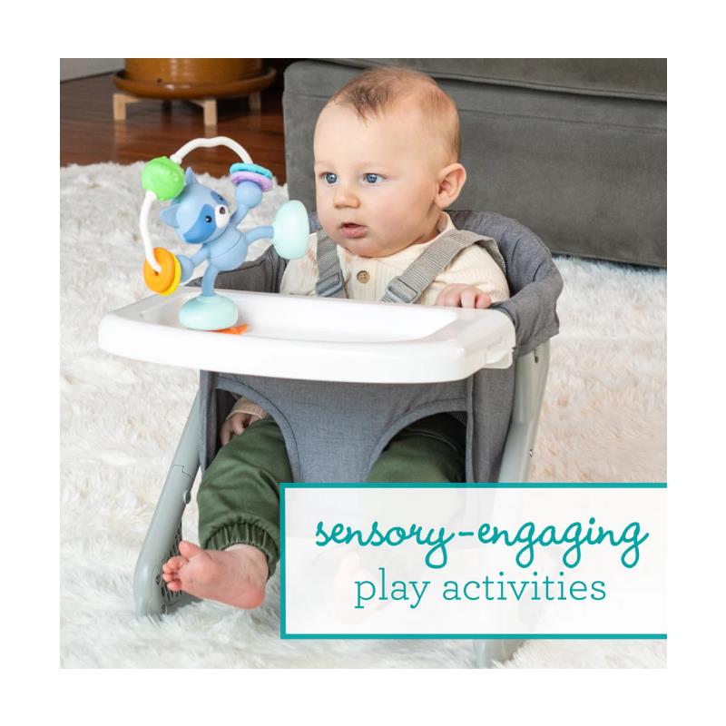 Infantino Stick & Spin Pal, Raccoon toy attached to a baby seat with a sitting baby engaging with it.