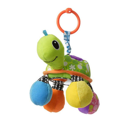 Soft green turtle toy with colorful accents and a hanging loop, designed for sensory play and visual stimulation.