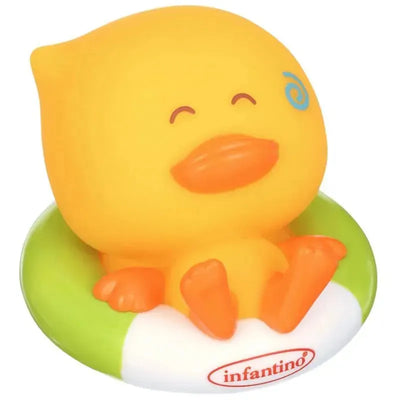 Yellow duck toy with a smiling face, sitting in a green and white inner tube, designed for bath time play.