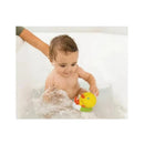 Baby playing in a bathtub, holding an Infantino Wee Wild Ones bath duck toy, splashing water.