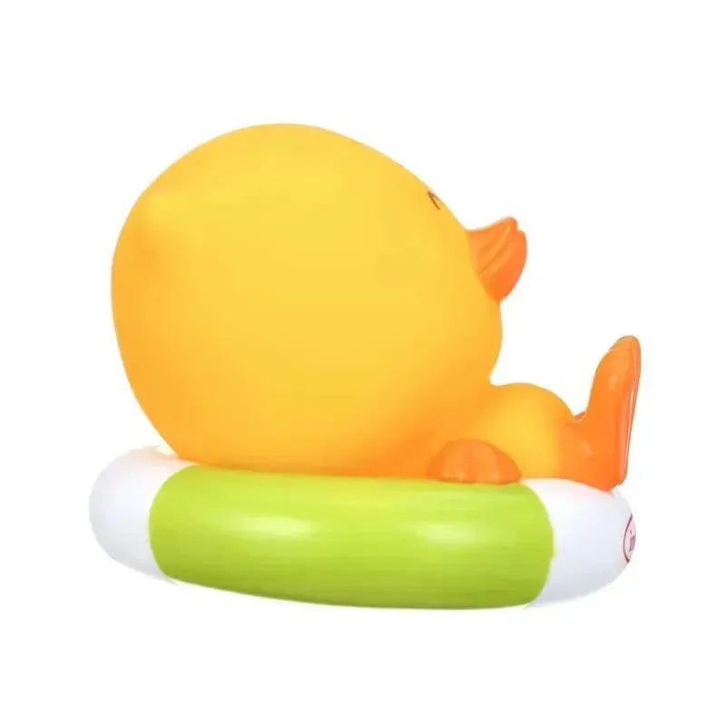 Yellow rubber duck sitting on a green inflatable ring, designed as a fun bath toy for children.