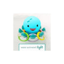Light-up octopus toy with colorful rings, designed for water play, featuring a smiling face and bubbles around it.