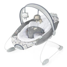 SmartBounce automatic baby bouncer seat in grey with plush material, a safety harness, and hanging plush toys.