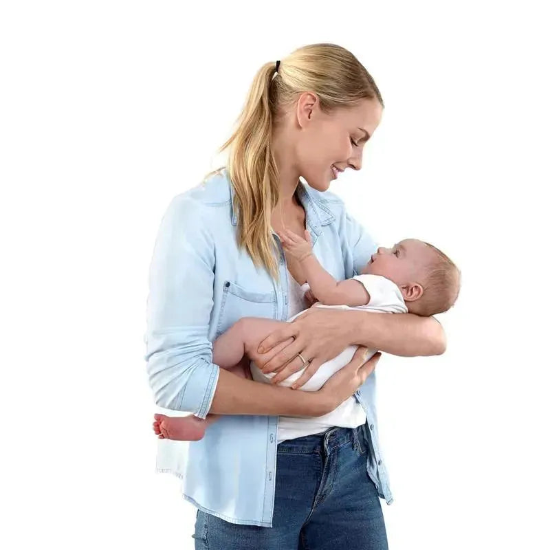 Woman holding a baby, both smiling at each other, showcasing a moment of connection and care.