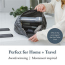 Inglesina Fast Dining Tray Plus being shown inside a bag, highlighting its portable design for home and travel use.