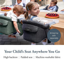 Charcoal gray Inglesina Fast Table Chair with high backrest and padded seat, used by children at a dining table.