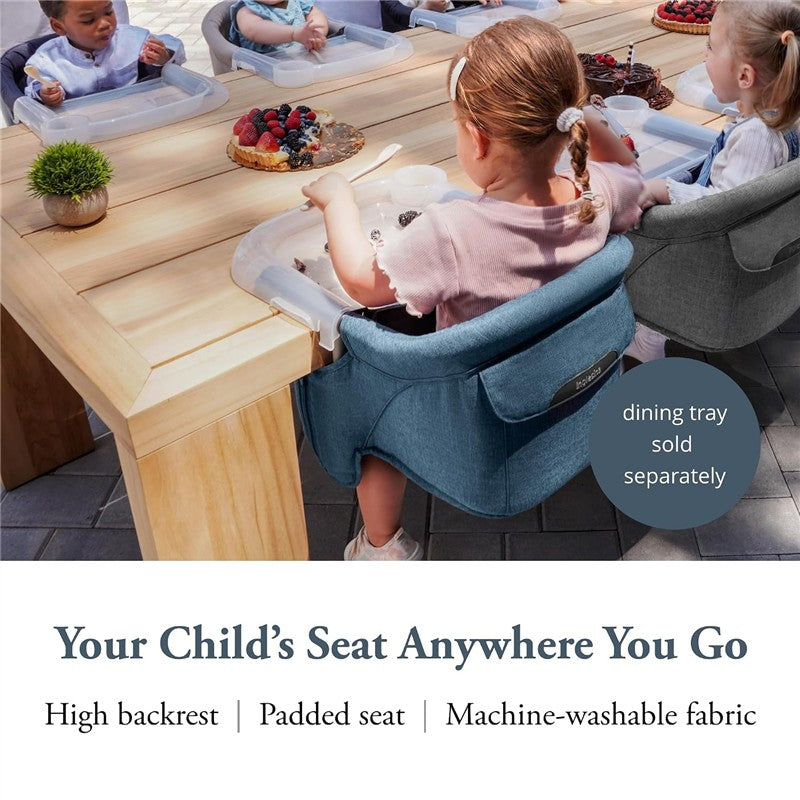 Inglesina Fast Table Chair in Slate Blue Melange, featuring a high backrest and padded seat, used by children at a dining table.