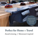 Inglesina Fast Table Chair in Slate Blue Melange attached to a wooden table, showcasing its suitability for home, outdoor, and travel use.