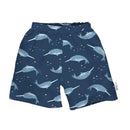 Eco-friendly navy swim trunks featuring a narwhal print and a built-in swim diaper for children.