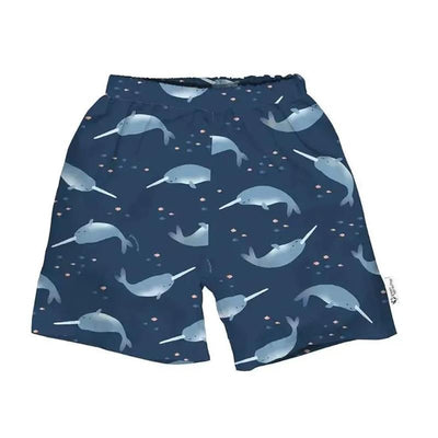 Eco-friendly navy swim trunks featuring a narwhal print and a built-in swim diaper for children.