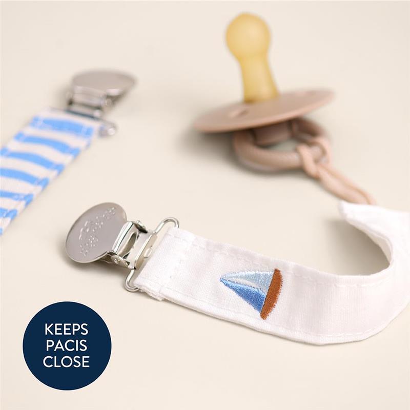 Itzy Ritzy 2-pack fabric pacifier straps featuring a blue and white striped design and an embroidered sailboat, designed to keep pacifiers close.