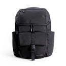 Modern unisex black backpack by Itzy Ritzy featuring multiple compartments and a front strap closure.