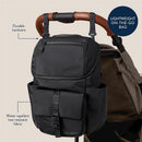 Modern unisex black backpack by Itzy Ritzy, featuring durable hardware, water-repellent fabric, and a front pocket.