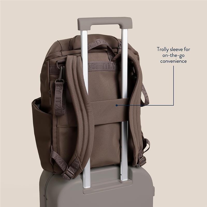 Modern unisex mocha backpack with trolley sleeve for convenience, displayed on a suitcase for travel use.