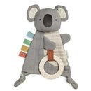 Koala-shaped crinkle toy featuring textured fabric, colorful tags, and a rubber teether ring for sensory play.