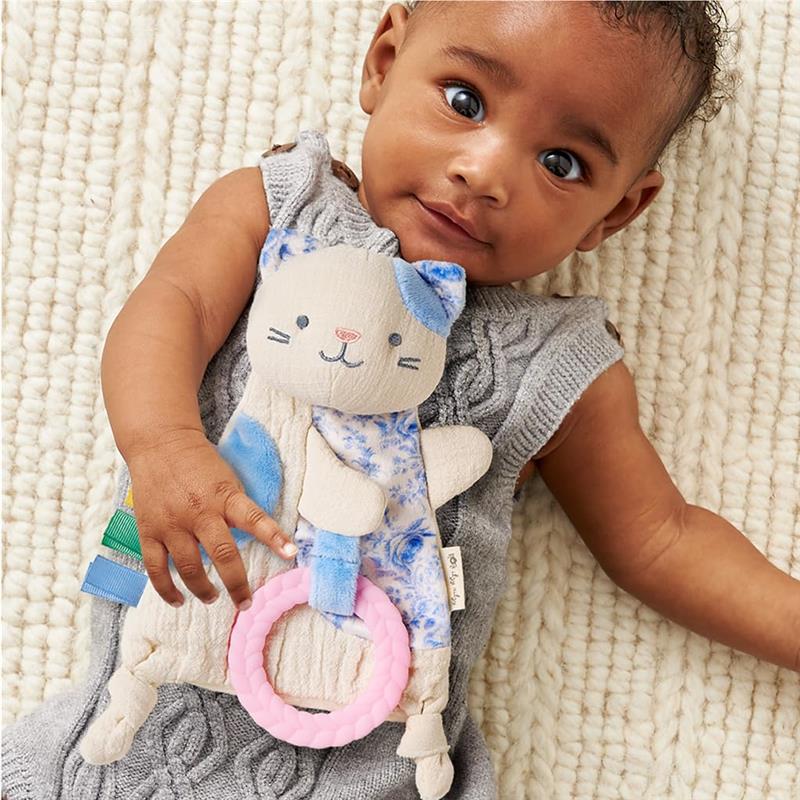 Kitty sensory toy with crinkle sound, held by a baby wearing a gray outfit, featuring colorful textures and a pink ring.