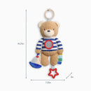 Brown teddy bear sensory toy with striped shirt, attached ring, sailboat, and colorful tags for developmental play.