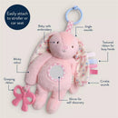 Sensory development toy featuring a pink bunny with textured ribbons, a mirror, crinkle sounds, and a grasping bow.