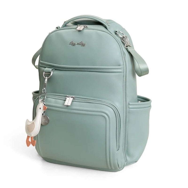 Light green Itzy Ritzy Boss Plus™ Backpack Diaper Bag with a duck-shaped pendant and multiple zippered compartments.