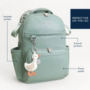 Mint green Itzy Ritzy Boss Plus™ Backpack Diaper Bag featuring a duck charm, insulated pockets, and external zip sleeve.
