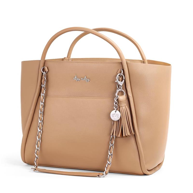 Chai latte Itzy Ritzy Boss Tote™ diaper bag features a sleek design, chain accent, tassel, and logo detail.