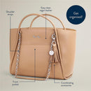 Chai Latte Boss Tote™ diaper bag by Itzy Ritzy, featuring shoulder straps, front pocket, and coordinating accessories.