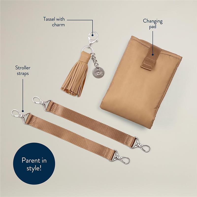 Chai Latte diaper bag accessories: changing pad, tassel charm, and stroller straps, featuring modern styling.