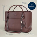 Espresso Itzy Ritzy Boss Tote™ diaper bag made from easy clean vegan leather, featuring a front pocket and shoulder strap.