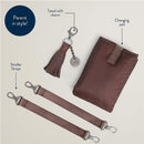 Itzy Ritzy Boss Tote™ diaper bag accessories, including a changing pad, tassel with charm, and stroller straps.
