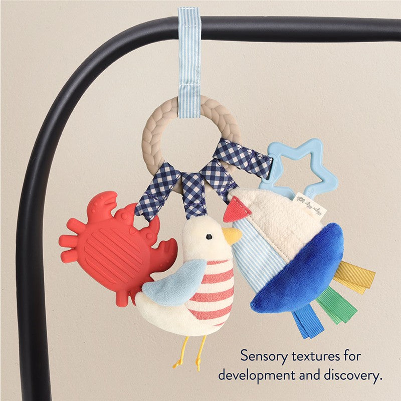 Itzy Ritzy Busy Ring teething toy featuring a lobster, bird, and star shapes, emphasizing sensory textures for development.