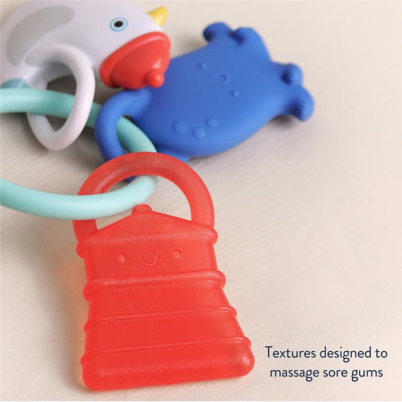 Multistage teething ring featuring a smiling red barn shape, blue animal, and white bird, with textures for soothing gums.